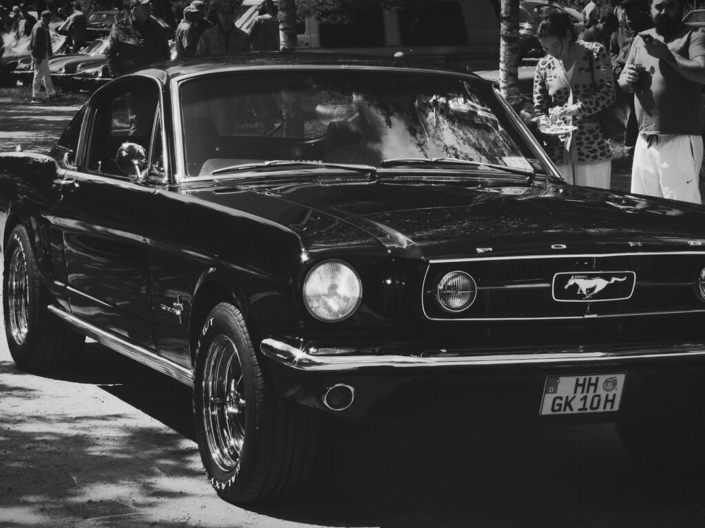 A black and white photo of an old mustang