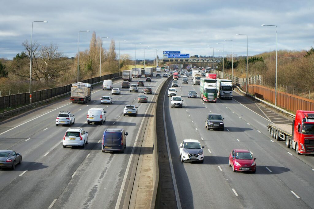 View of cars and trucks on a busy highway in St Albans, UK during daytime.