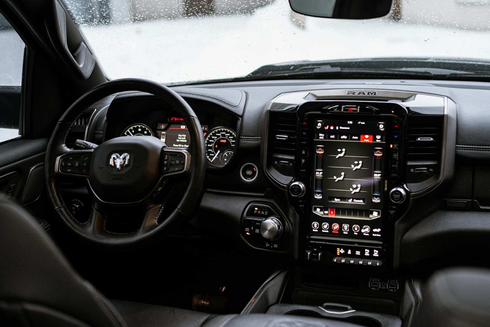 Close-up view of Dodge Ram 1500 Rebel truck dashboard and steering wheel in a modern interior.