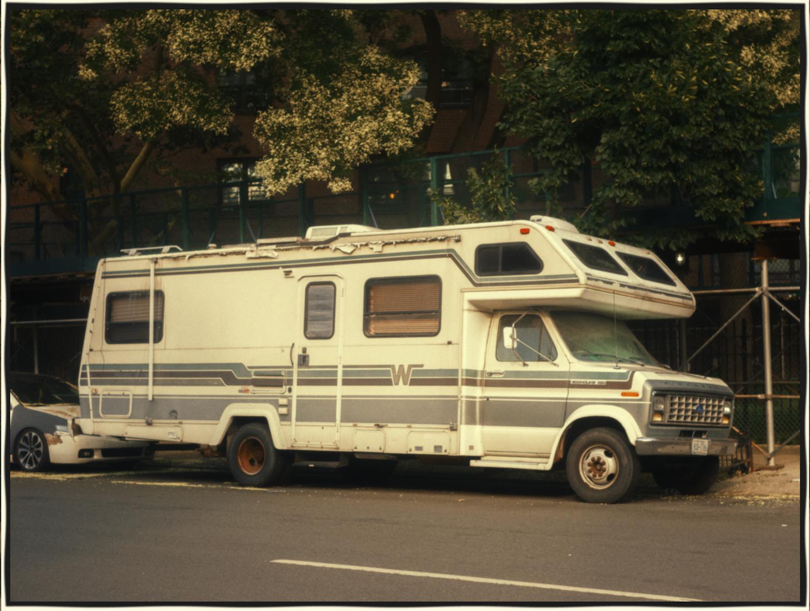 Classic Winnebago RV parked on a city street, exemplifying urban camping adventure.