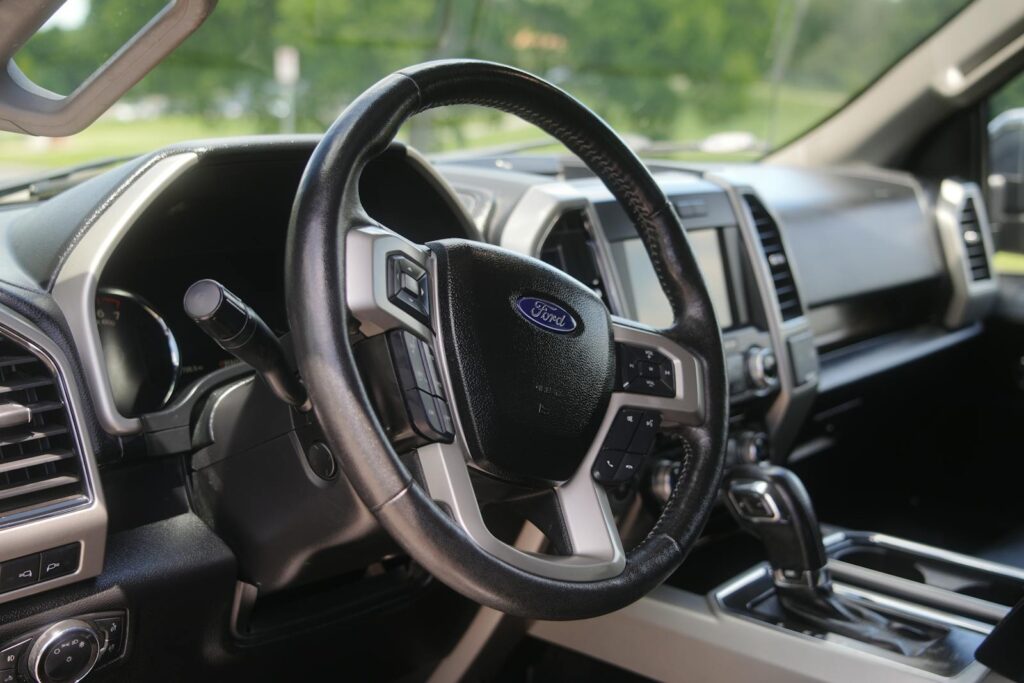 Close-up of the Ford F-150 interior showcasing the dashboard and steering wheel, perfect for automotive enthusiasts.