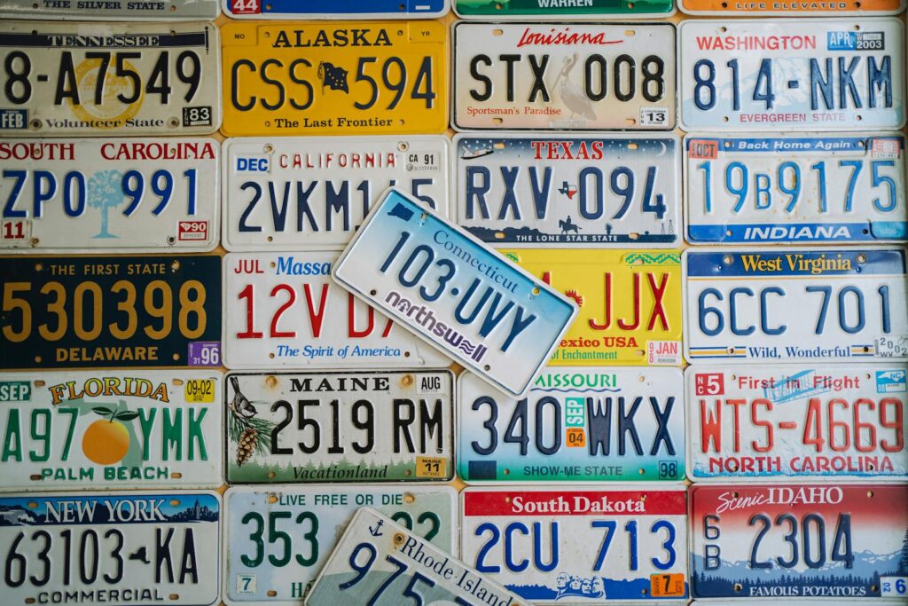 A colorful collage of vintage US license plates from various states on display.