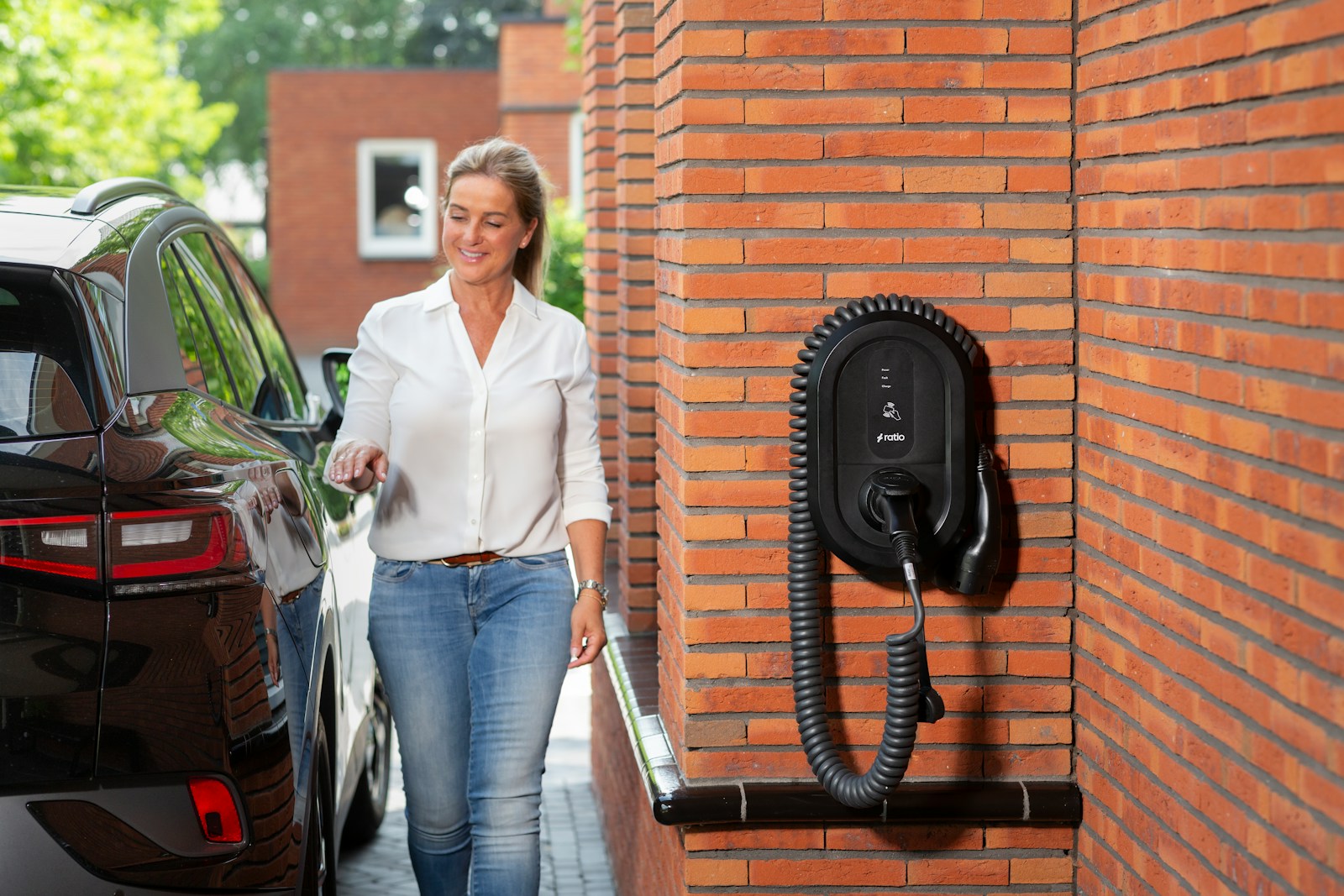 Woman walking towards electric car charging station