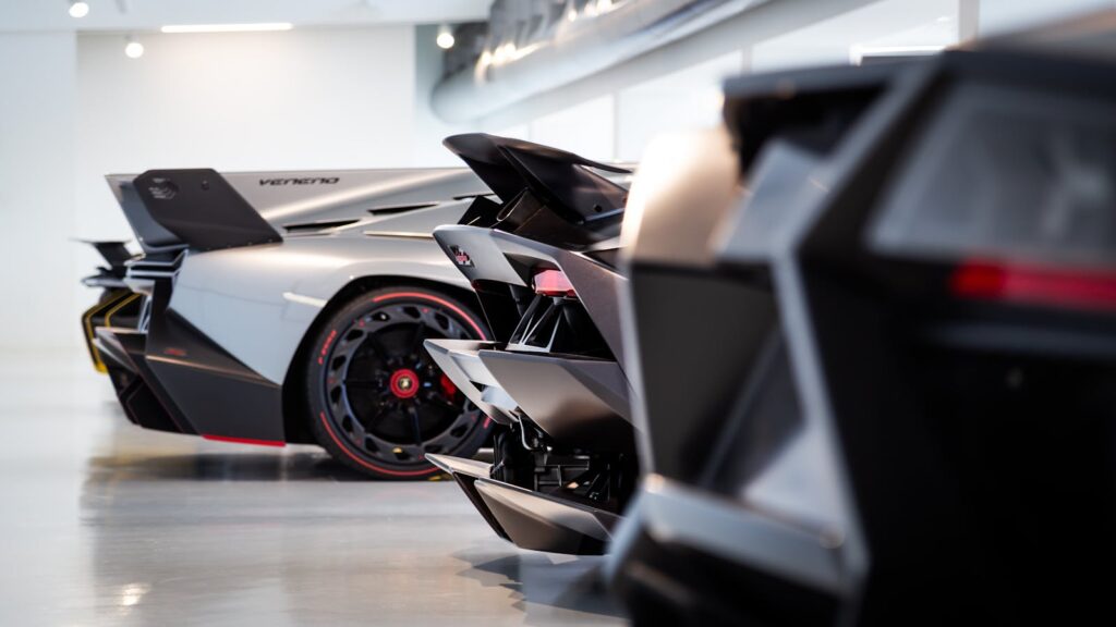 Close-up of elegant supercars in a contemporary indoor showroom.