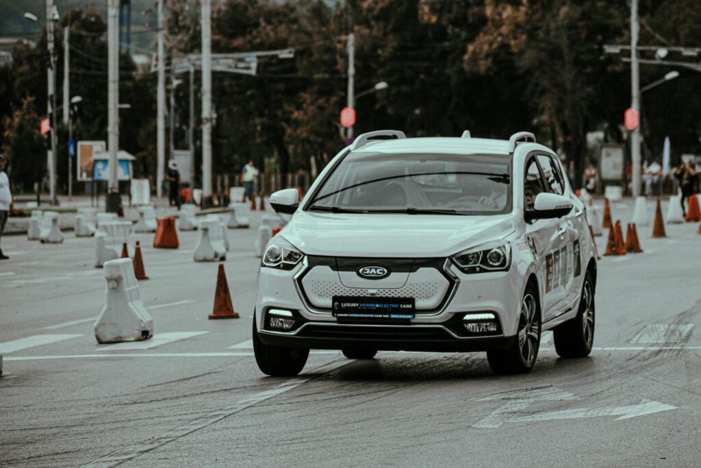 White car racing during urban rally and driving down paved street in daylight