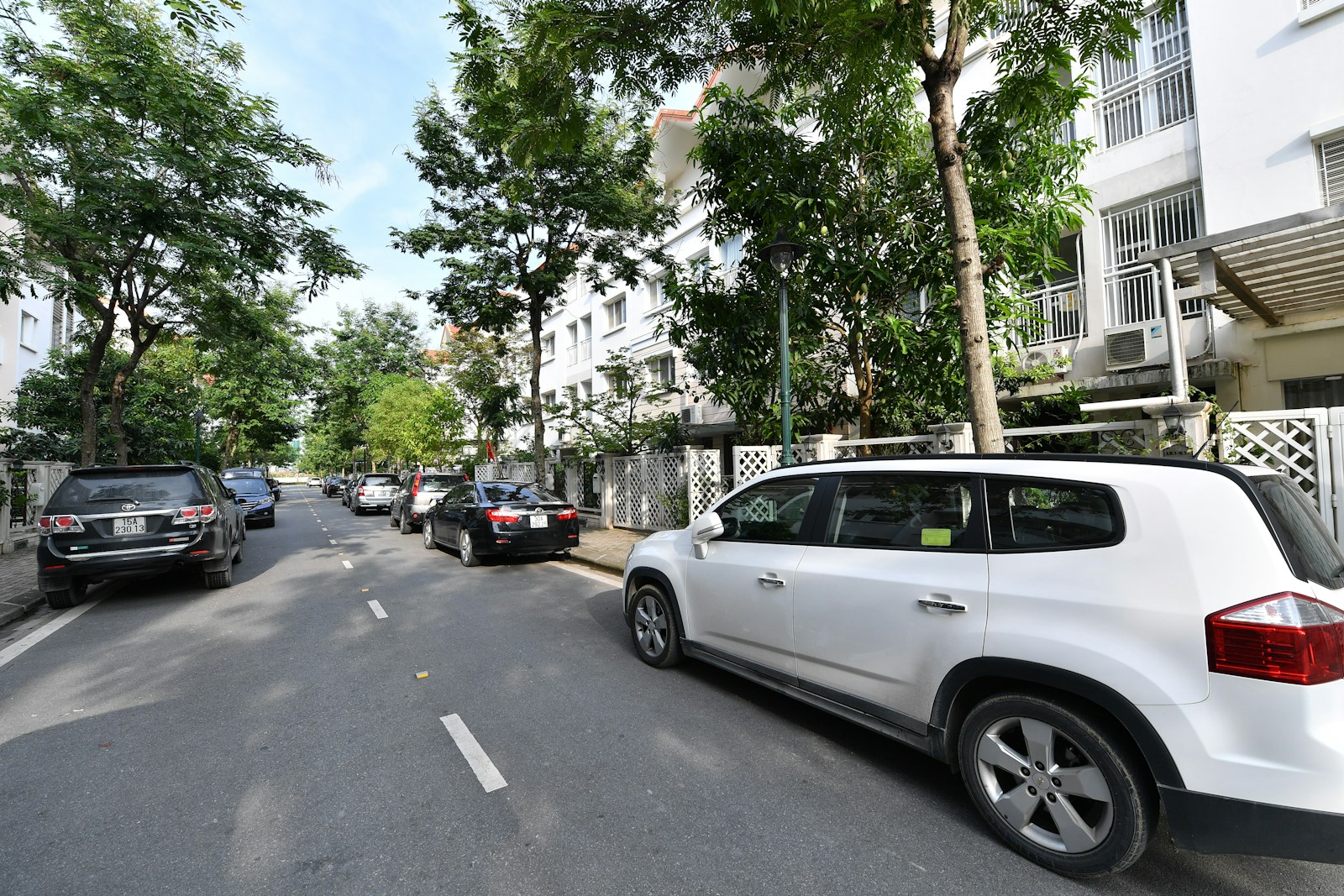 a white car parked on the side of a street