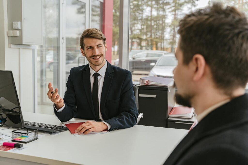 Two businessmen having a conversation in a modern office setting.