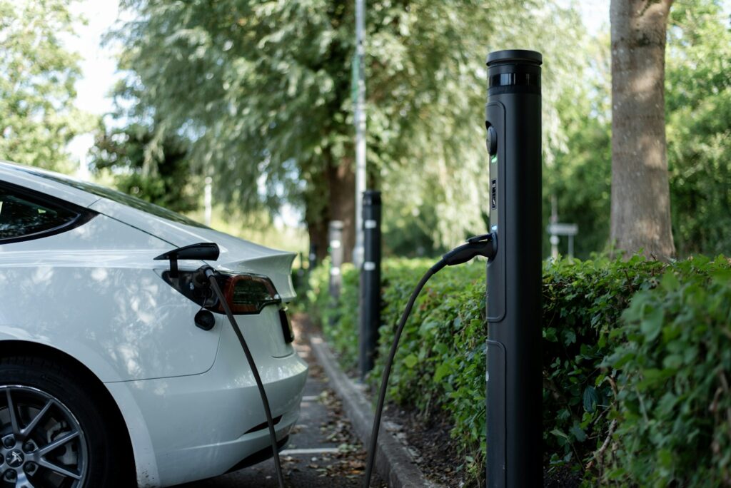 An electric car is charging at a station.