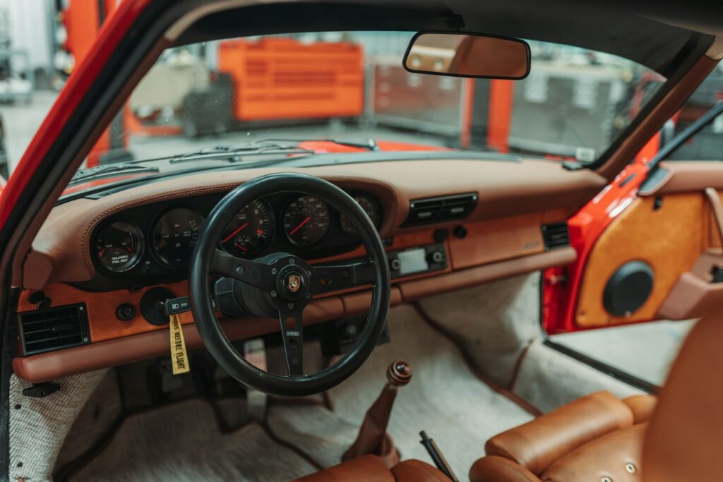 Interior of a vintage red sports car dashboard.
