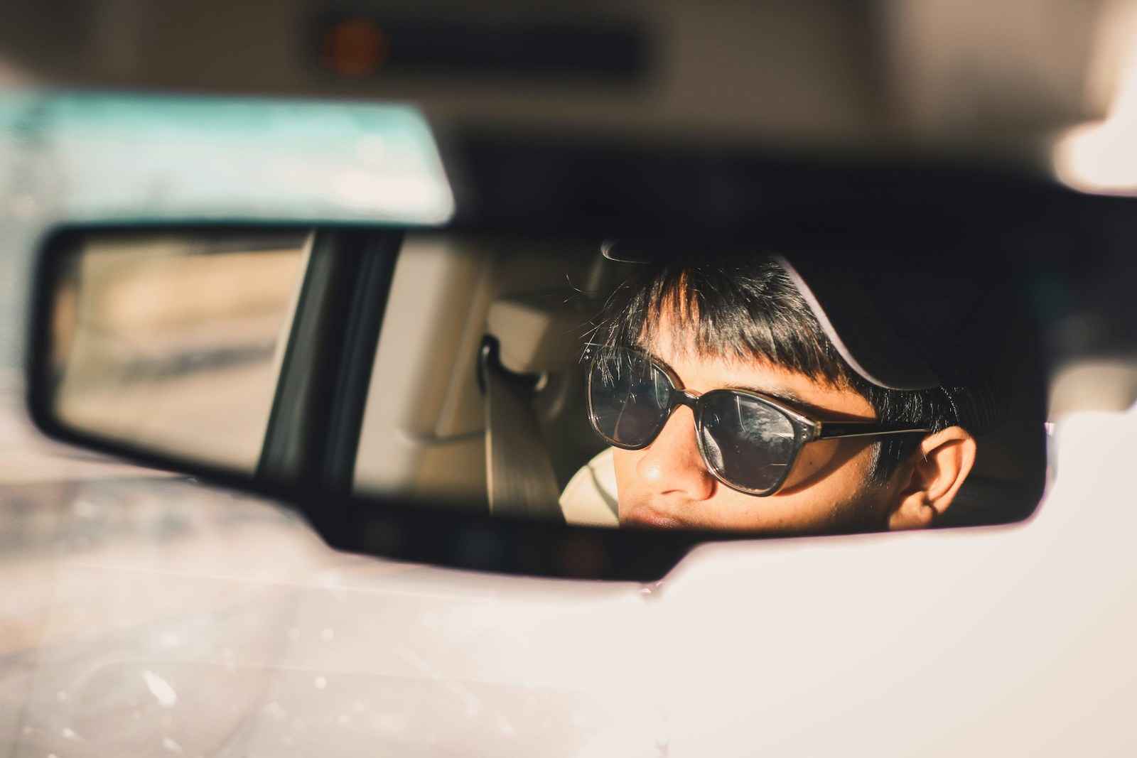 person wearing black sunglasses in car