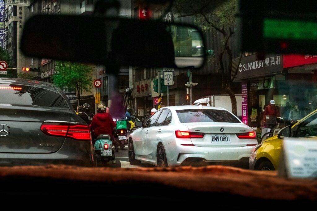 Cars and scooter in city traffic jam