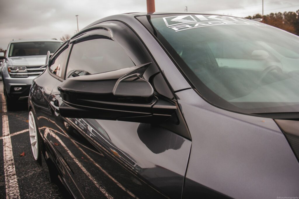 a line of cars parked in a parking lot