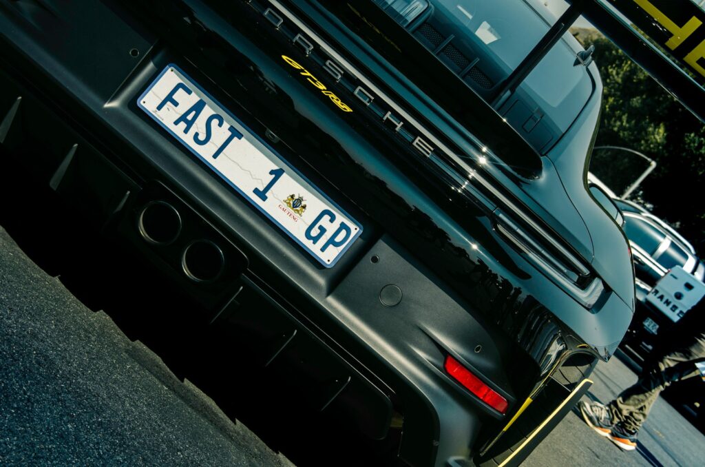 Rear view of a black porsche with custom license plate