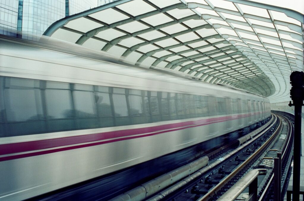 Modern train speeding through a futuristic station.