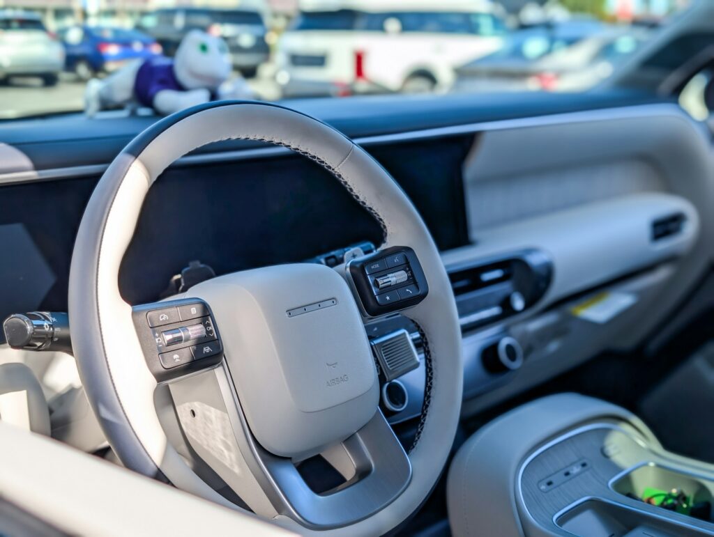 Modern car interior with steering wheel and dashboard