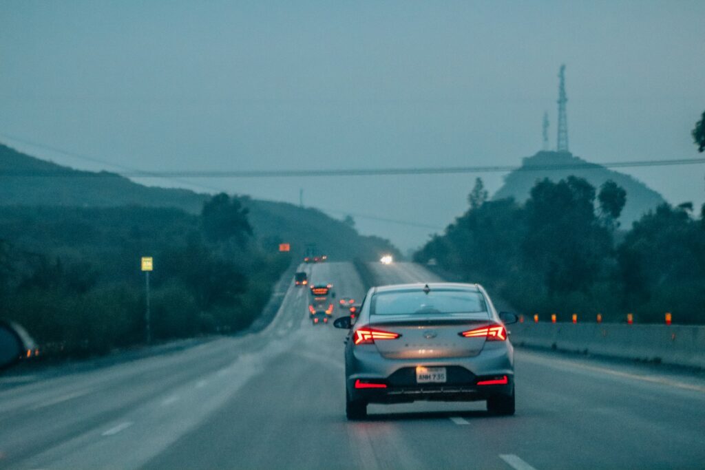 A car driving down a highway in the rain