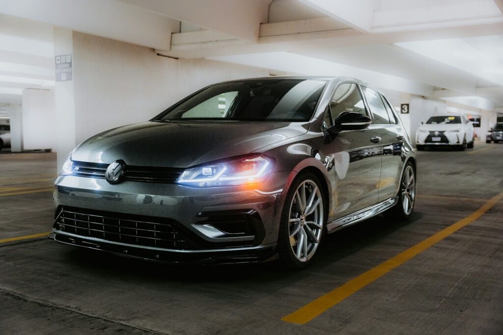 A dark grey volkswagen golf parked in a garage.