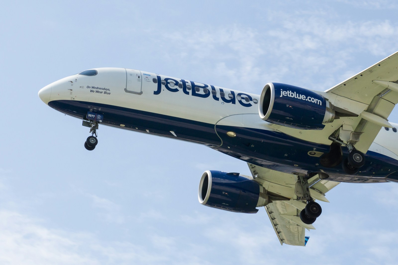 a jetblue airplane is flying in the sky