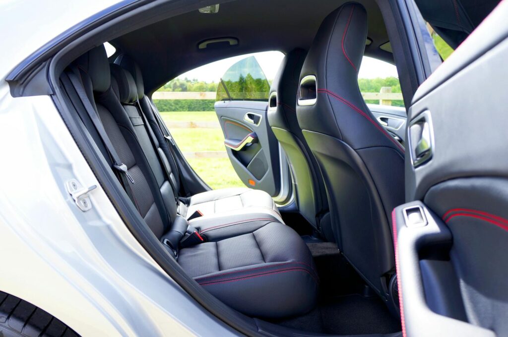 Detailed view of a car's interior showing the open back doors, emphasizing design and space.