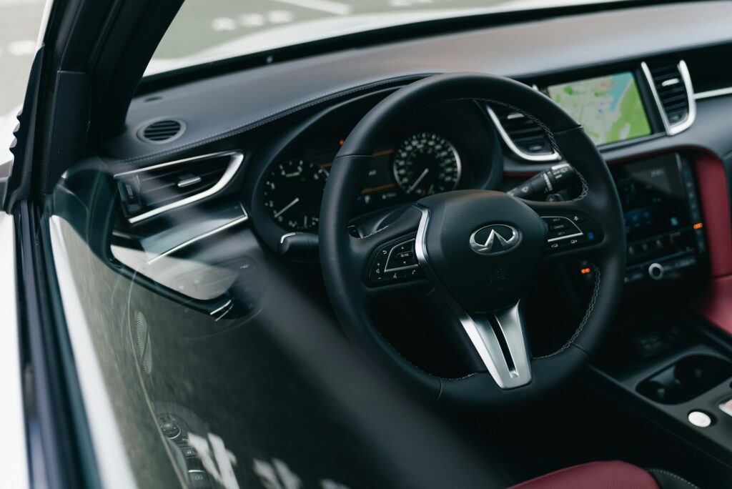 Modern car interior with leather seats and navigation screen.