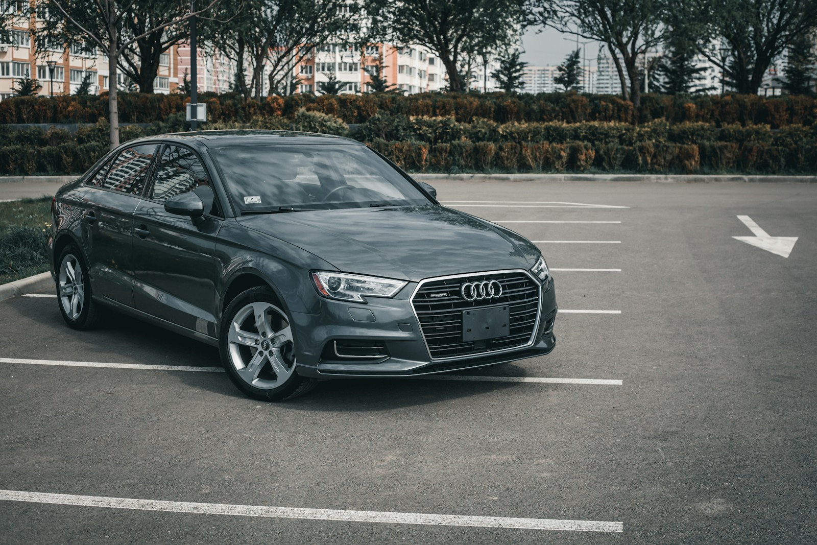a grey car parked in a parking lot