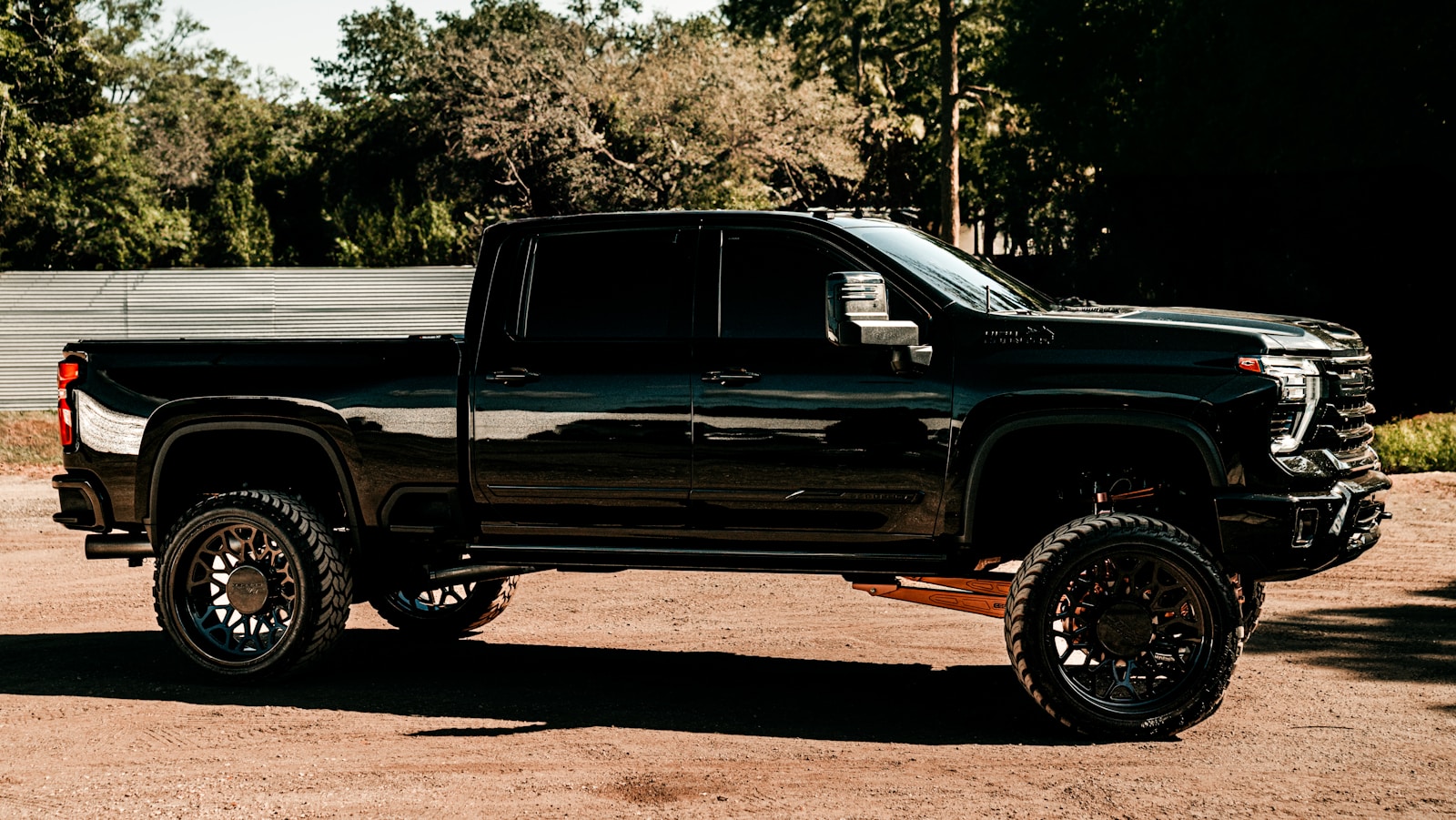 a black truck parked in a parking lot