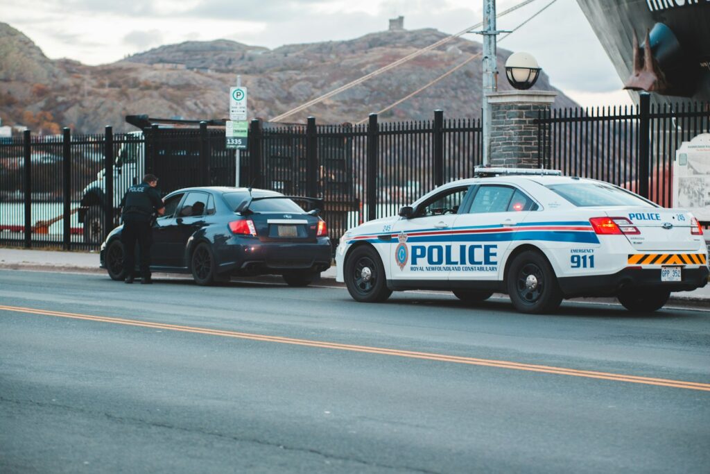 blue and white police car on road during daytime