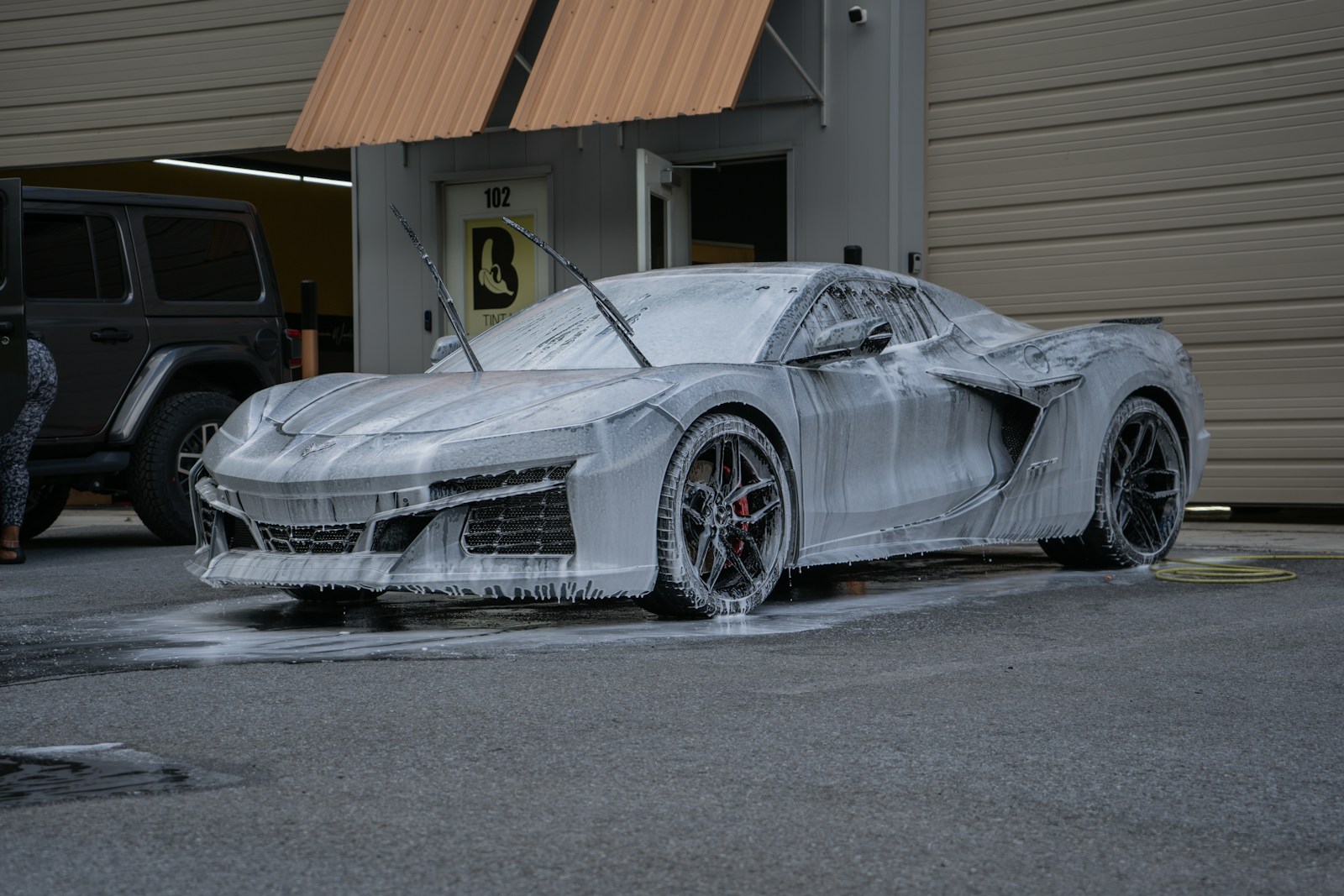 A corvette getting a bubbly, soapy wash.