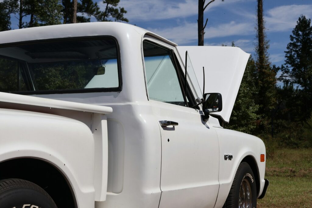 a white truck parked on the side of a road