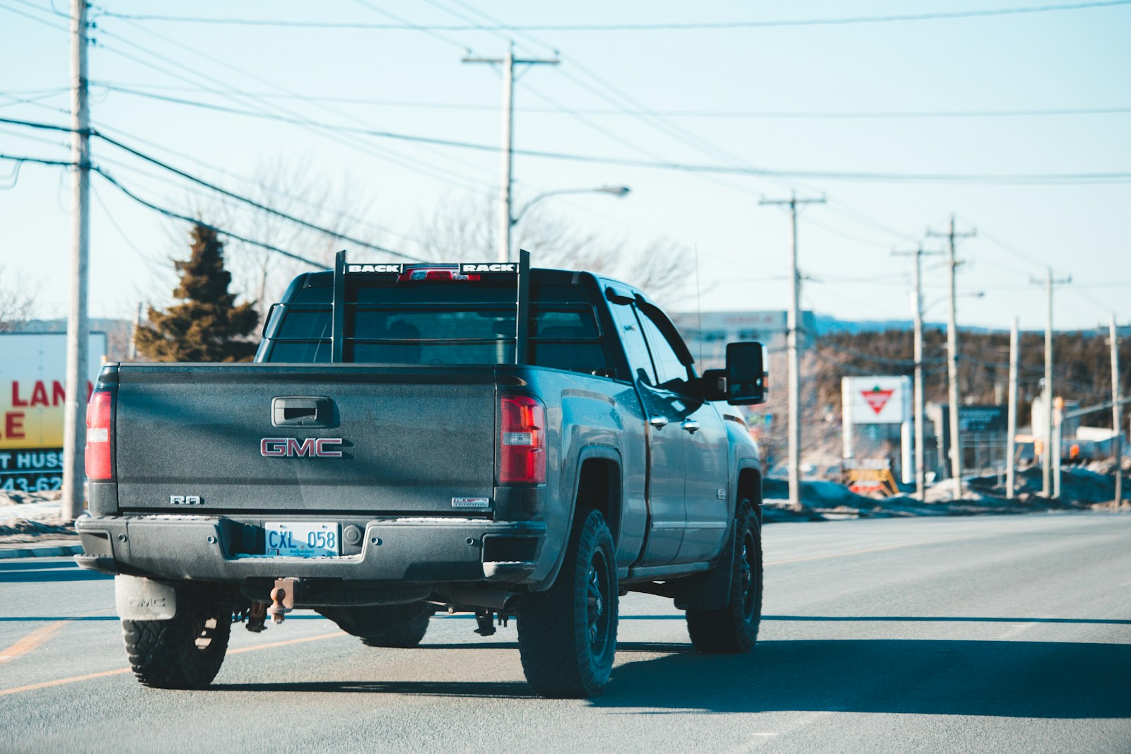 blue chevrolet crew cab pickup truck on road during daytime