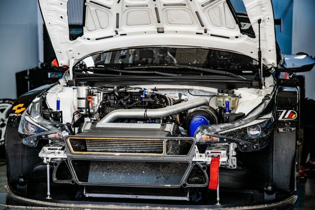 White race car engine compartment with hood open