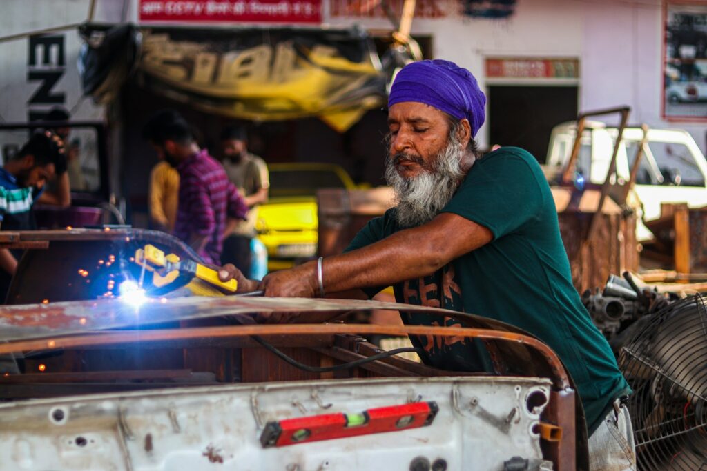 a man with a beard working on a car