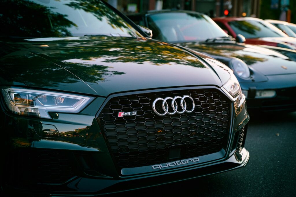 Close-up of a dark audi car grille and headlights.