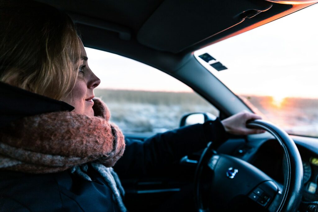 woman driving vehicle during daytime