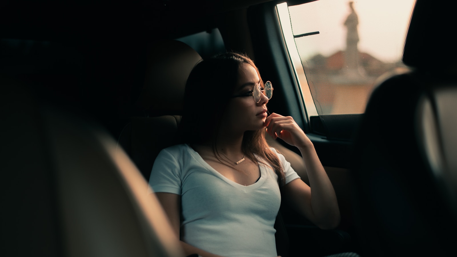woman in white shirt sitting inside car