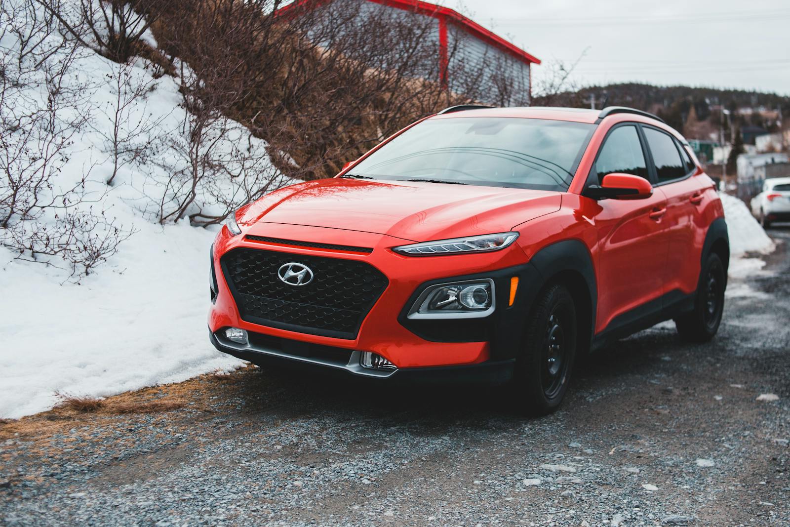 A red Hyundai SUV parked outdoors on a snowy day, showcasing modern design and style.