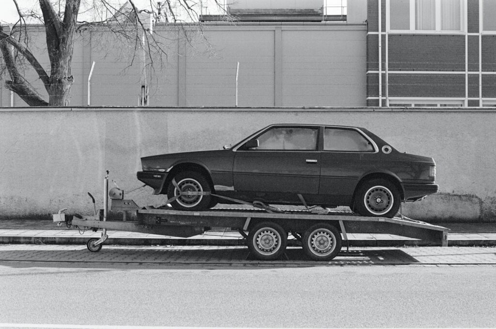 a car is being towed on a flatbed trailer