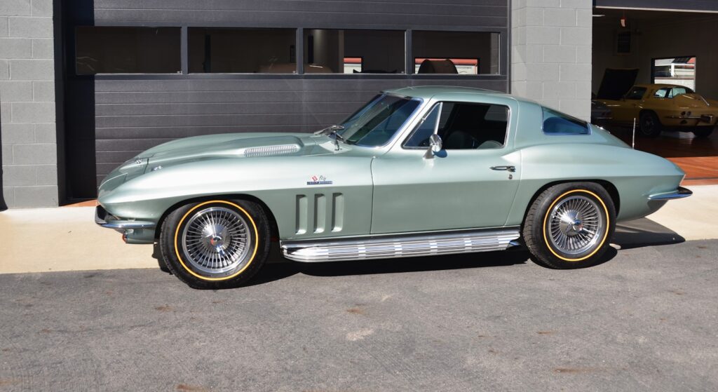 A vintage light green chevrolet corvette stingray coupe.