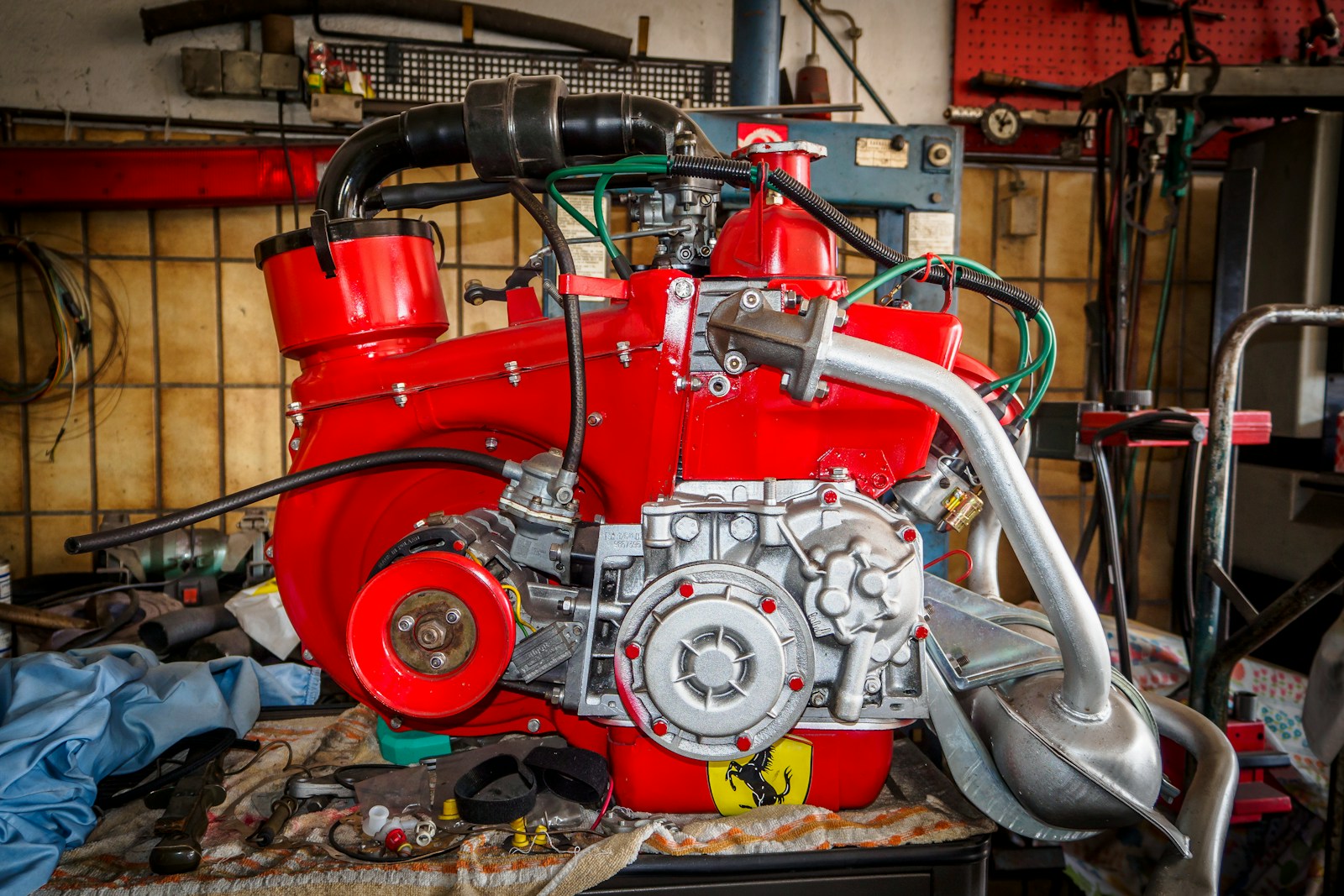a close up of a red engine in a garage