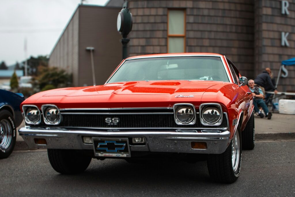 A red car parked in front of a building