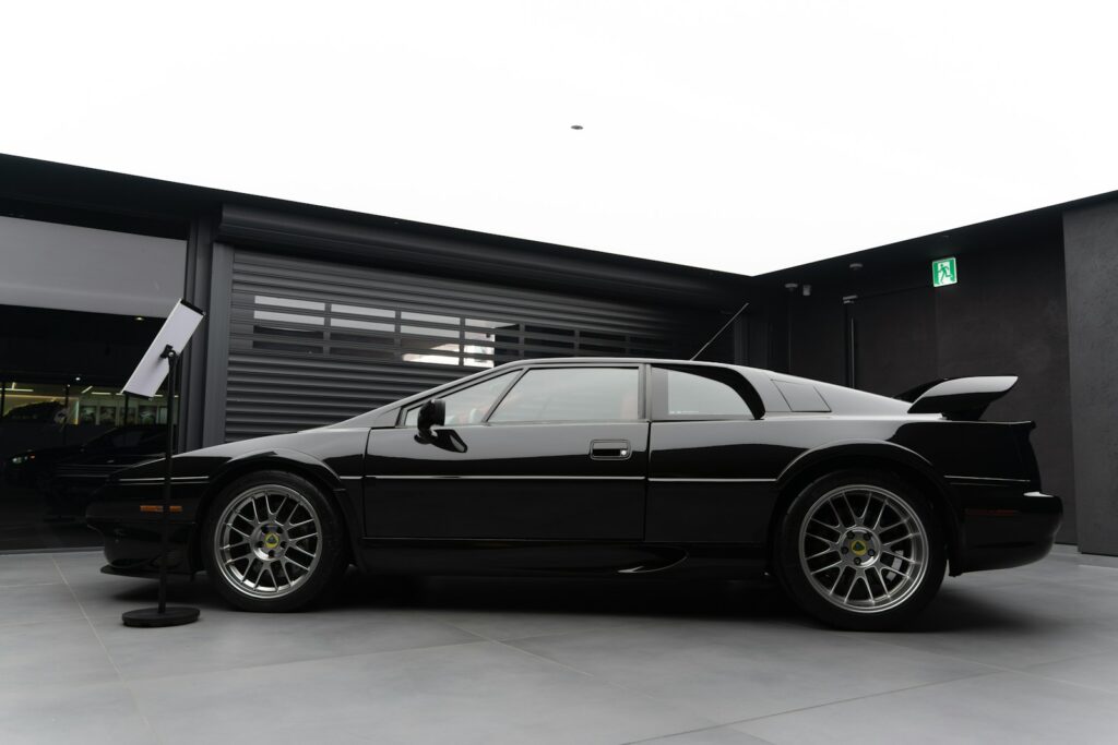 a black sports car parked in front of a garage