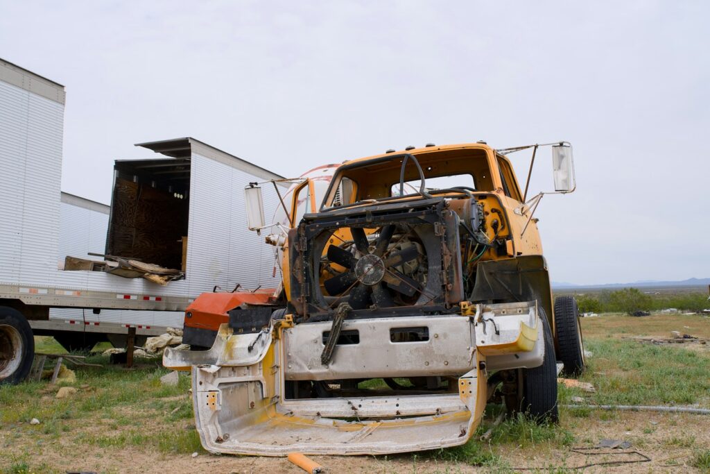 Abandoned truck chassis with damaged engine compartment
