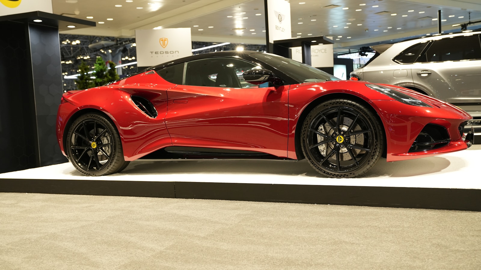 a red sports car on display in a showroom