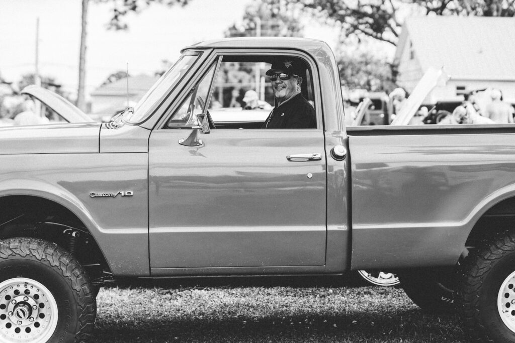 Man sitting in a vintage pickup truck