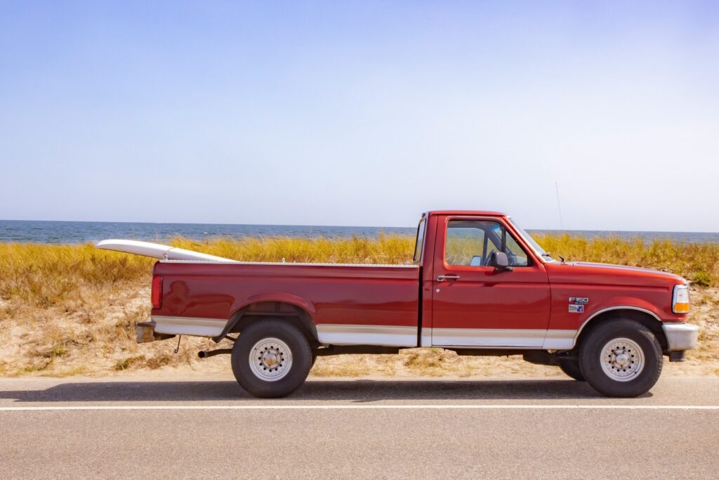 brown crew cab pickup truck on road during daytime
