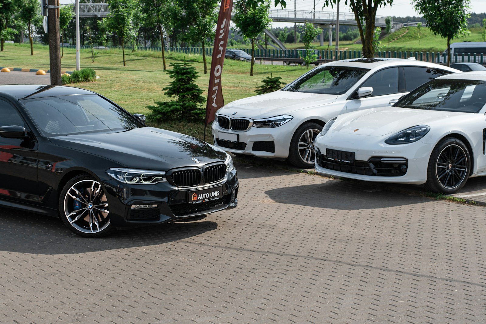 a group of cars parked on a brick road