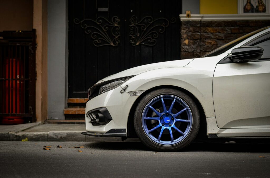 A white car parked on the side of the road