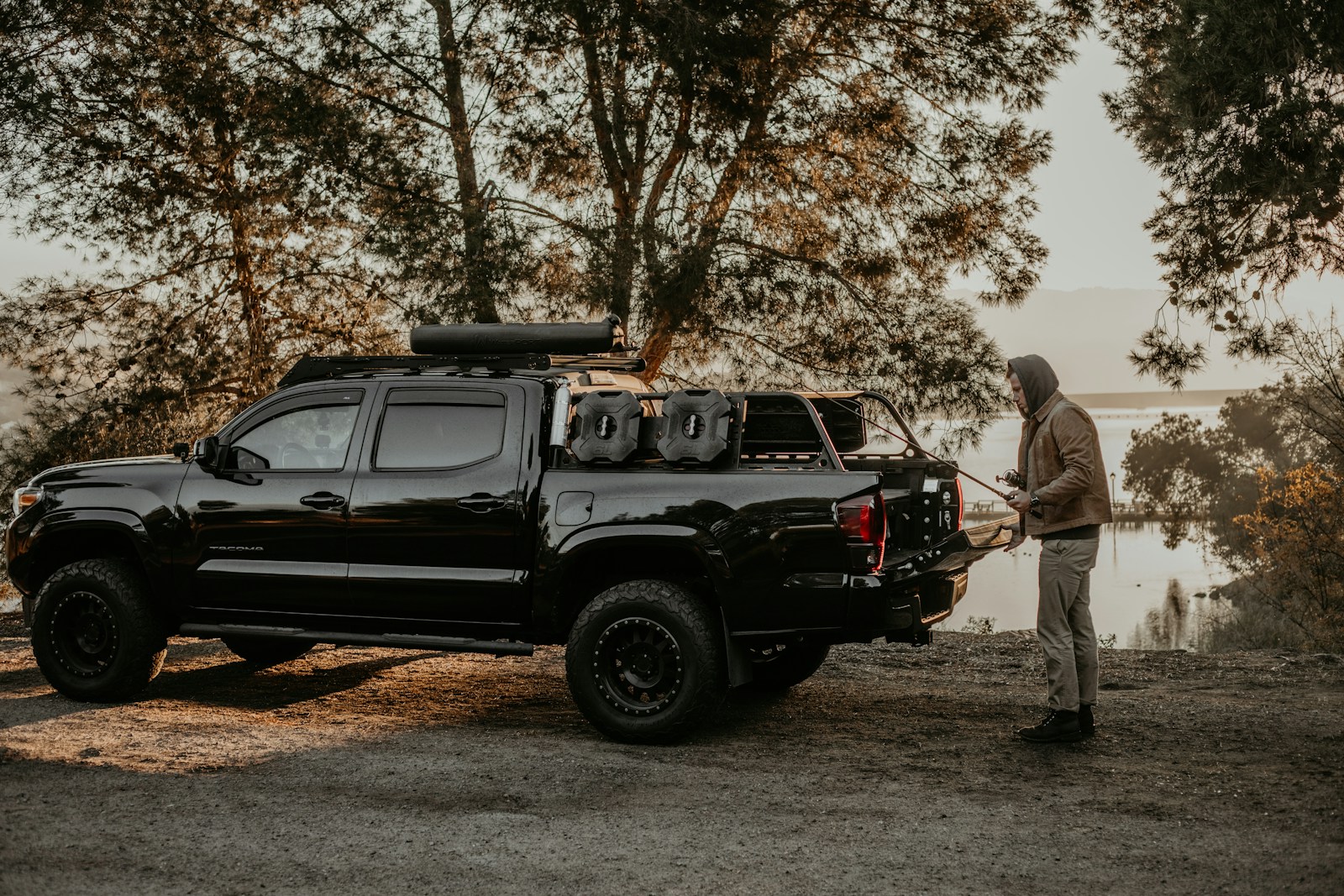 a man standing next to a black truck