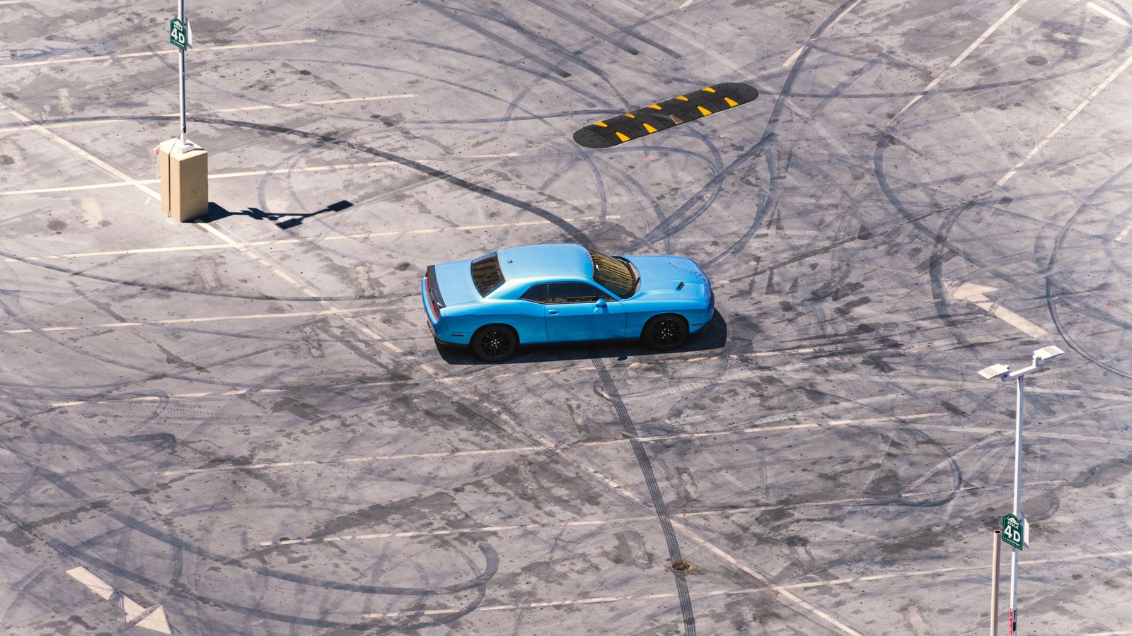 Blue sports car drifting in Las Vegas parking lot. Dynamic automotive action.