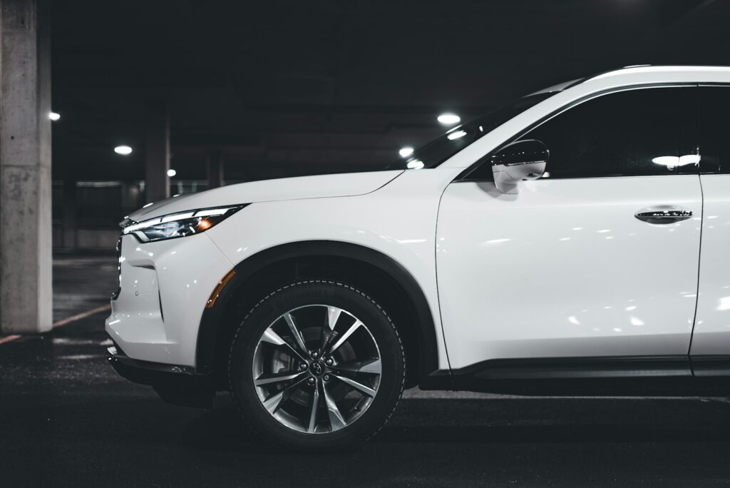 a white suv parked in a parking garage
